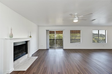 Unfurnished living room with visible vents, dark 