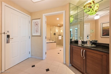 Bathroom with a shower stall, vanity, tile pattern