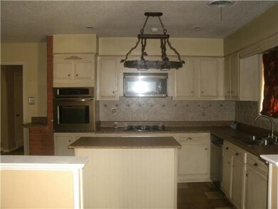 Kitchen has some updates, island and tile flooring