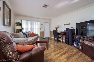 Living area featuring crown molding, wood finished