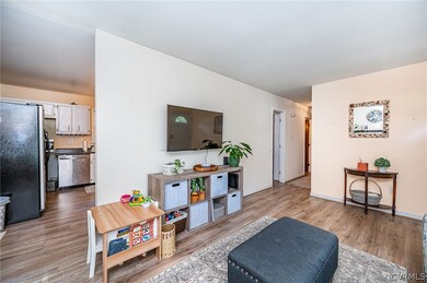 Living room with view of kitchen, entry to laundry
