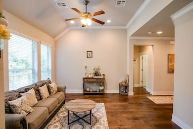 Living room with ceiling fan, dark wood-style flo
