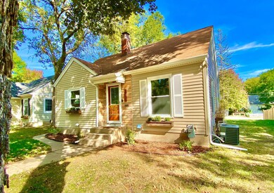 CUTE 1.5 Story - brick accents and shutters add charm to the front entry.