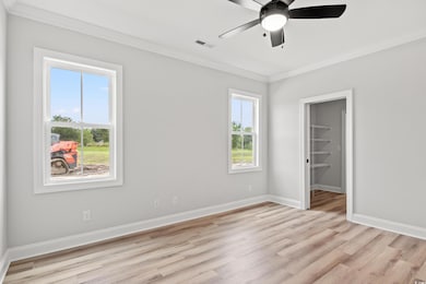 Unfurnished bedroom featuring ceiling fan, a spaci