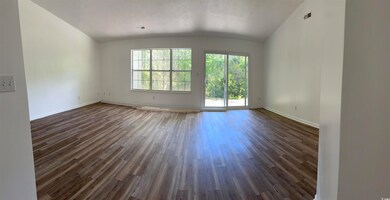 Unfurnished room with lofted ceiling, baseboards, 