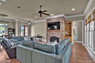Living room featuring ceiling fan with notable cha