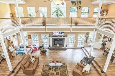 Living area with wood finished floors, a high ceil
