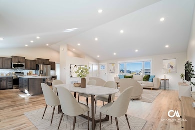 Virtually staged. Dining room with light wood-style floors, recessed lighting, and high vaulted ceiling