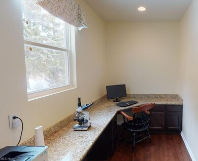 Planning center off kitchen with granite counterto