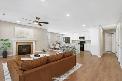 Virtually staged living room and kitchen.