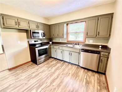 The updated kitchen has stainless appliances, new countertops, and new laminate flooring.