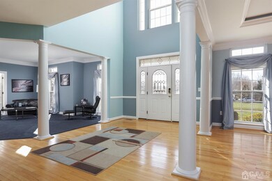 The grand two story foyer is light filled and invi