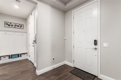 Front door entrance with garage and laundry room a
