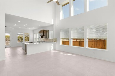 Unfurnished living room featuring a ceiling fan, 