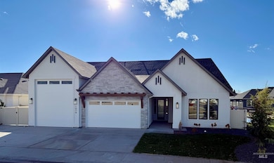 View of front of property with an attached garage, driveway, roof with shingles, and stone siding