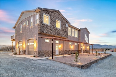 View of front of home featuring stone siding, stuc