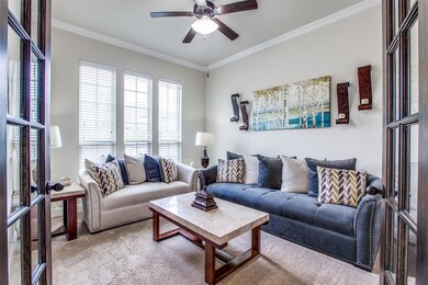 Carpeted living room featuring ornamental molding 