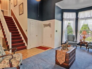2 story foyer with laminate wood flooring and larg