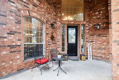 The front porch is all brick with a large window a