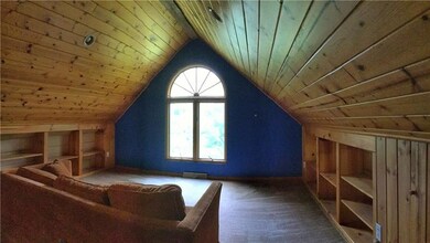 14x13 loft with built-in book cases and vaulted ce