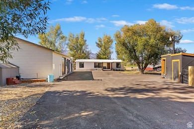 Rear view of property with an outbuilding