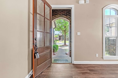 Foyer with wood finished floors and baseboards