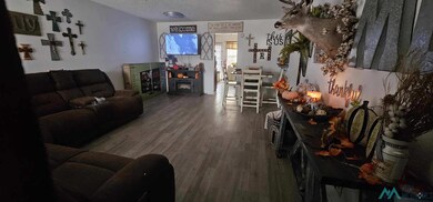 Living room featuring a textured ceiling and wood finished floors
