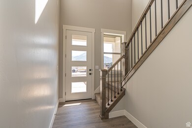 Entryway featuring stairs, dark wood-style flooring, and a mountain view