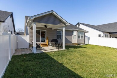 Back of house featuring a ceiling fan, a fenced backyard, a patio, entry steps, and a shingled roof