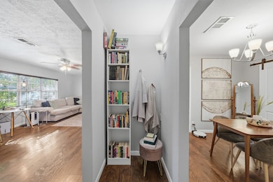 A small nook with bookshelves adds charm in between the living area and dining room.