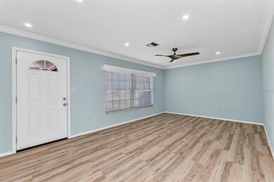 Living room features new vinyl flooring, lighting and blinds.
