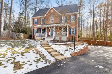 Colonial inspired home featuring covered porch