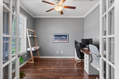 Bright home office with gray walls, wood flooring,