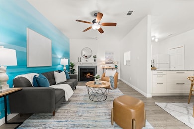Living area featuring ceiling fan, light wood-typ