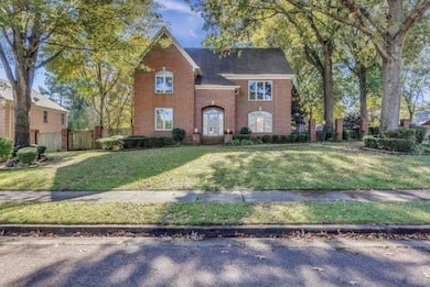 Traditional-style home featuring brick siding