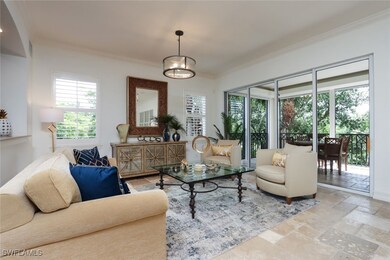 Living room featuring ornamental molding, stone ti