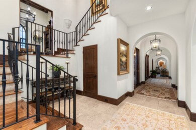 This foyer with dramatic soaring ceilings welcomes