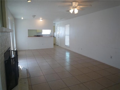 Unfurnished living room featuring light tile patte