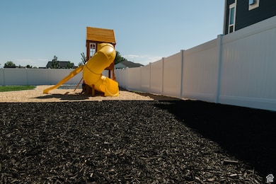 Community play area featuring a fenced backyard