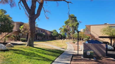 View of property's community featuring a yard and stairs