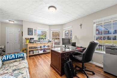 Home office with light wood-style flooring and baseboards