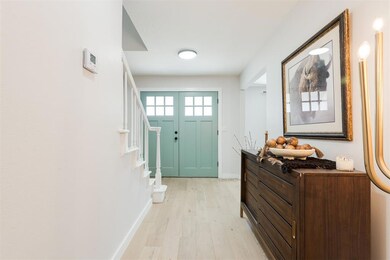 Entryway with stairway, light wood-style flooring,
