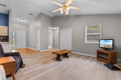Living room with ceiling fan, light hardwood / woo