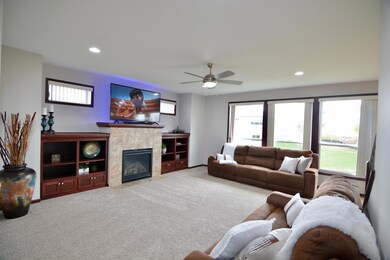 Large Main level family room with gas fireplace and custom built-in cabinets with transome windows above.