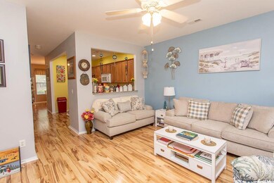 Living room with light wood-style flooring and ceiling fan