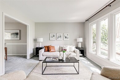 The bright formal living room flows into the dinin