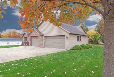 Three bay garage and ample parking pad/driveway.