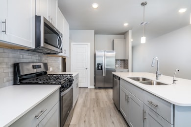 Modern kitchen with white granite countertops and