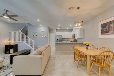 Living room featuring stairway, a ceiling fan, rec