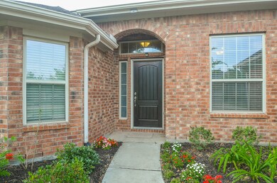 Warm brick around the entryway lends itself to the perfect relaxing backdrop. Expansive windows let all the sunshine inundate this amazing home